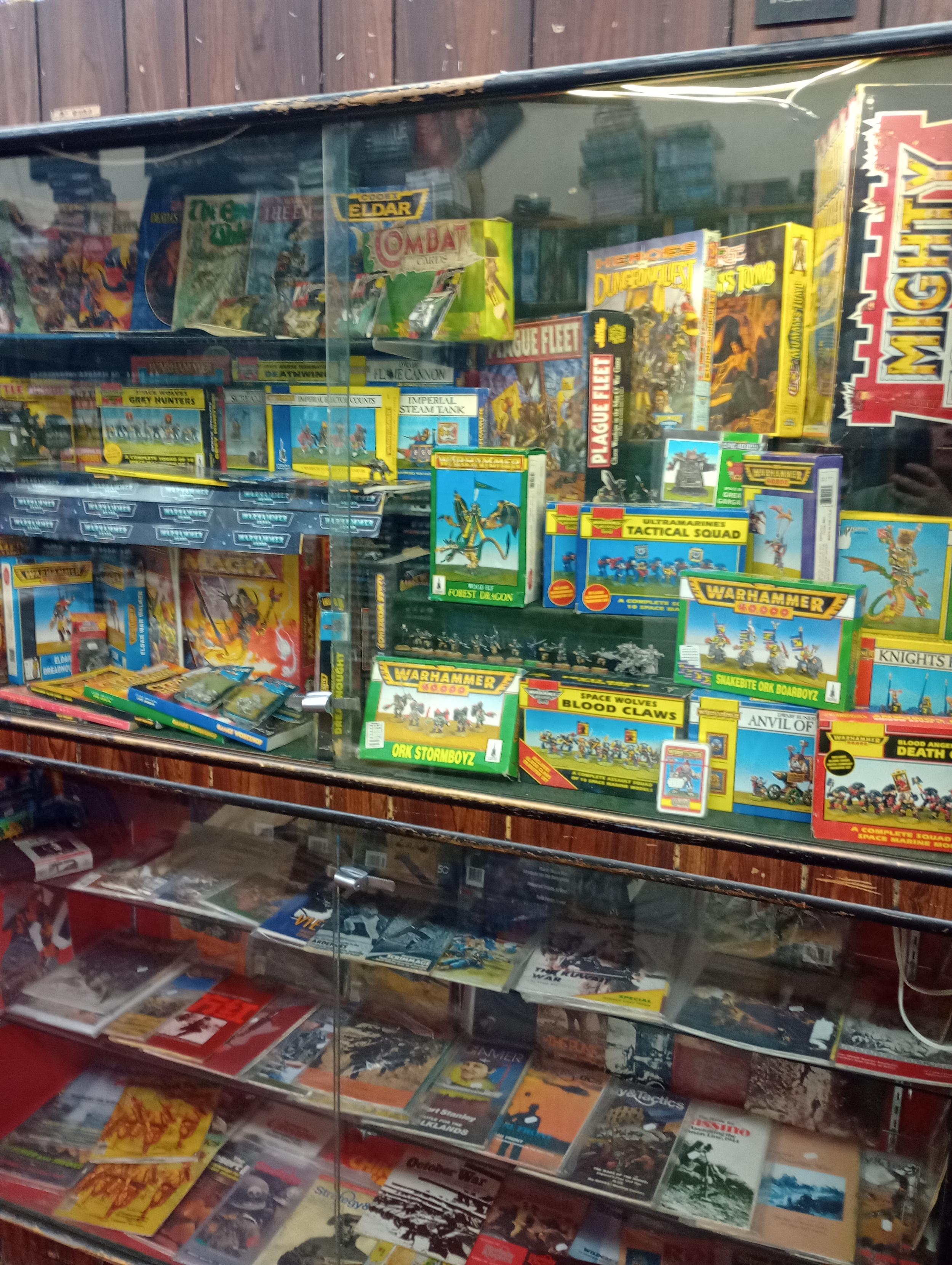 Glass case filled with classic Warhammer stuff