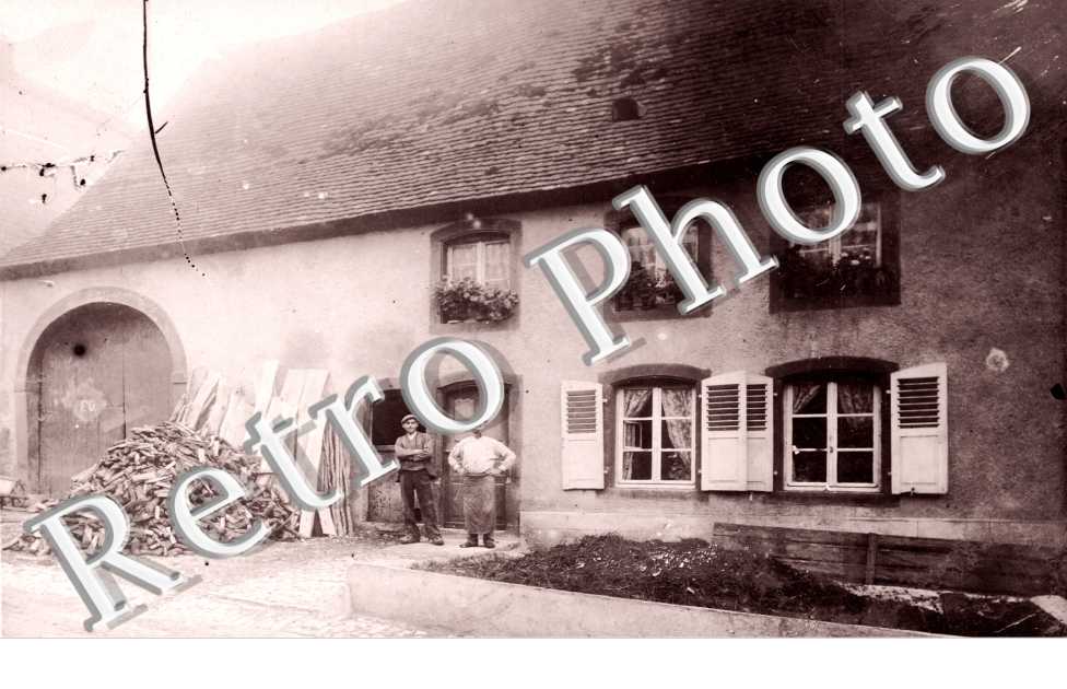 Deux hommes pris en photo devant une Ferme