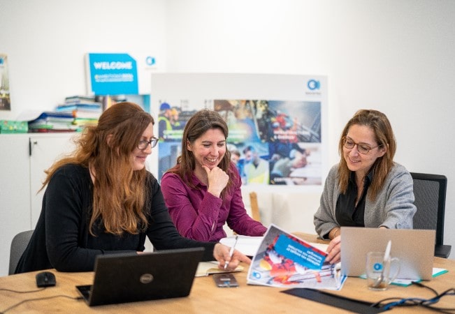 Our mission visual of three employees working