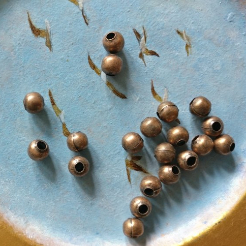 Lot de 20 perles à gros trou cuivre de 6 mm de diamètre extérieur.