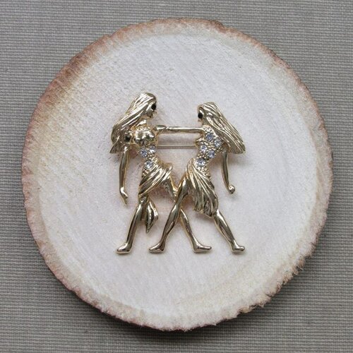 Broche bijou signe du zodiaque gémeaux en acier doré.