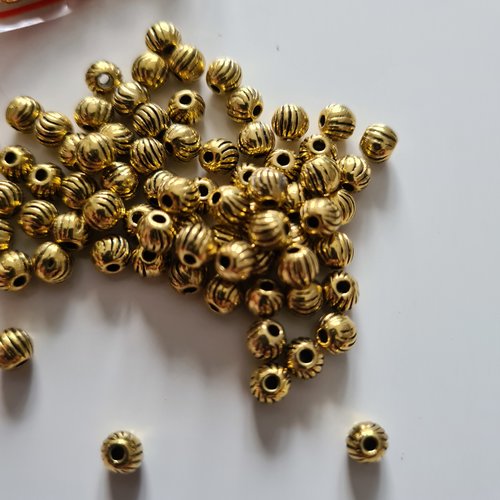 Lot de 10 perles balle rayée dorée 5mm