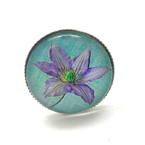 Bague argentée, fleur mauve sur fond turquoise par breloques et cie