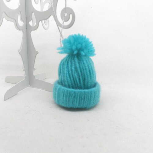 N°27 petit bonnet à pompon en laine n°33  bleu turquoise  fil élastique argenté à accrocher