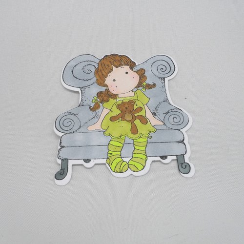 N° 2039 découpe d'une  petite fille assise sur fauteuil   n°24  avec un tampon encre noir  sur  papier blanc  et colorée