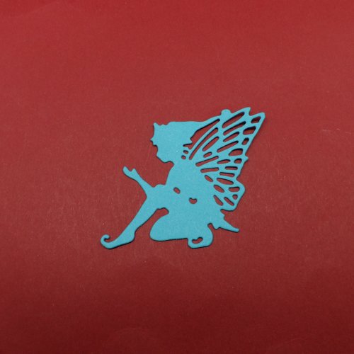 N°1323 un "lutin  papillon" n°1  assis  en papier bleu turquoise  découpage fin