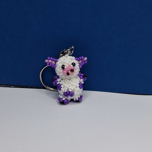 Porte-clés vache blanche et violette en perles