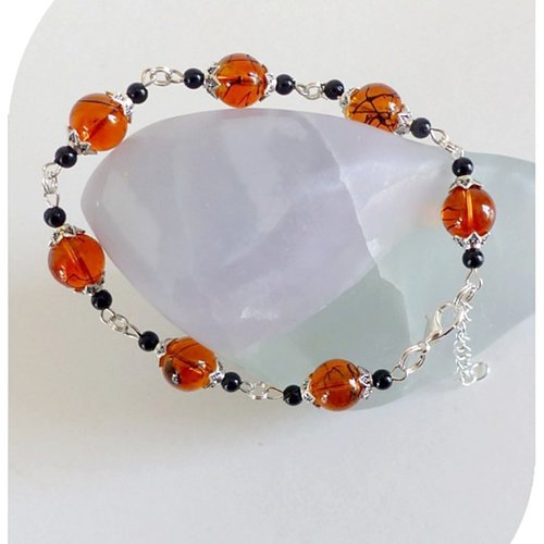 Bracelet perles de verre oranges et noires . fermoir mousqueton.
