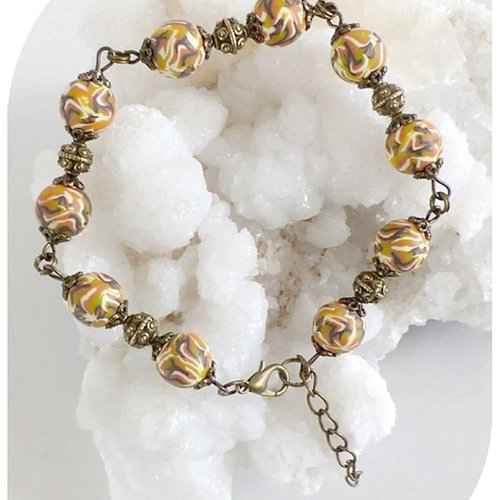 Bracelet perles fantaisie en mousse et perles métal couleur bronze.