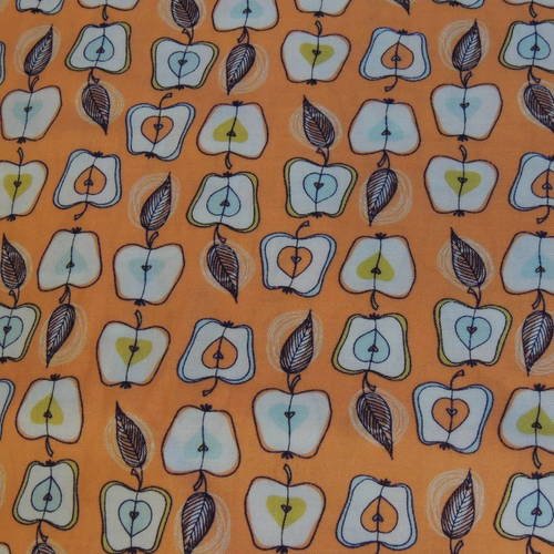 Coupon de tissu coton fond orange motif pommes 