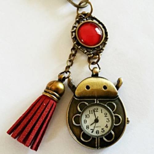 Bijou de sac/porte clés "montre coccinelle" bronze et rouge, coccinelle bronze, cabochon en verre et pompon  rouge