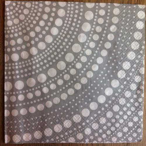 Serviette en papier motif graphique pois blancs disposés en cercle sur fond gris" 