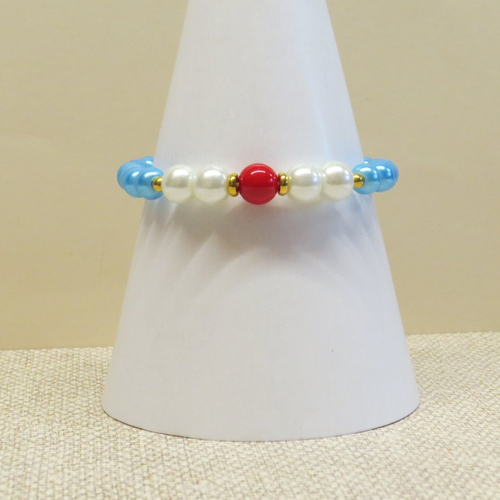 Bracelet perles de verre rouge, blanche et bleu et sa breloque fleur doré.