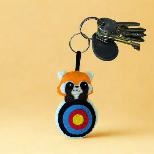 Porte clé tir à l'arc, panda roux dans une cible