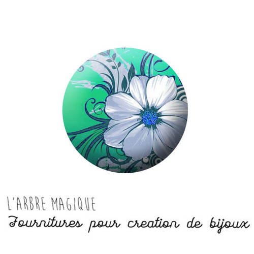Cabochon à coller fleur blanche fond vert bleu verre 25 mm - ref 877 
