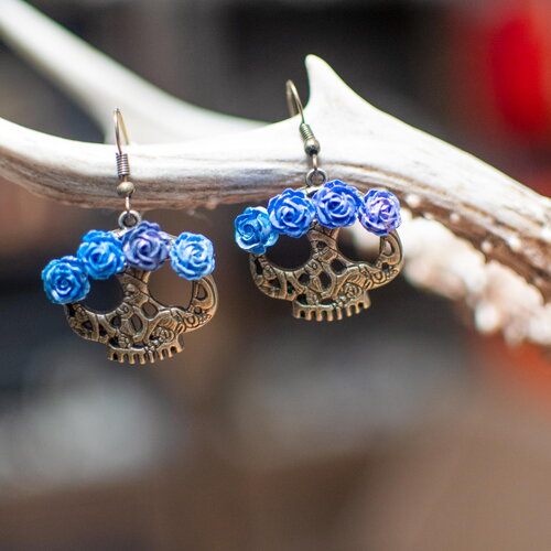 Boucles d'oreilles pendantes avec crânes ethniques et roses en camaïeu de bleu bohème façon calavera, inspiration día de los muertos