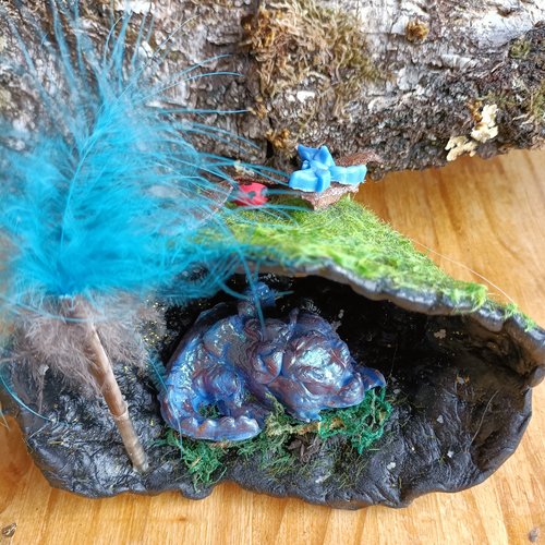 Dragonneau endormi dans sa tanière – sculpture féerique en porcelaine froide