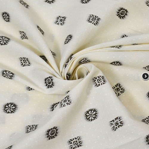 Tissu en coton, écru à petits plumetis, avec des décors brodés bruns, un peu transparent, vente par 25 cm sur 150 cm
