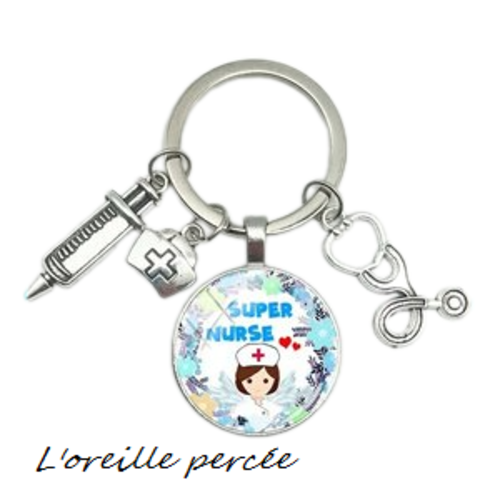 Porte clé argenté cabochon infirmière et ses breloques