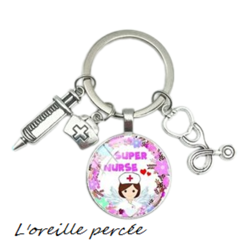 Porte clé argenté cabochon infirmière et ses breloques