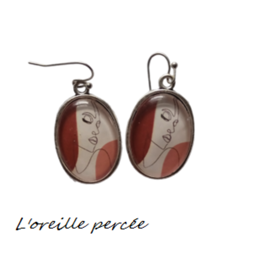 Boucle d'oreille visage abstrait
