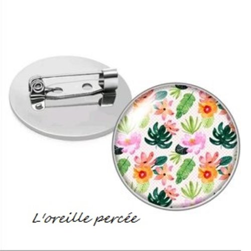 Broche ronde cabochon fleuri et feuille tropicale