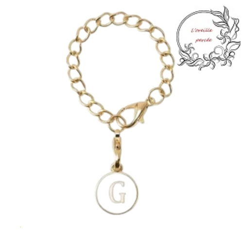 Bijou de sac chaîne dorée et son médaillon blanc lettre g