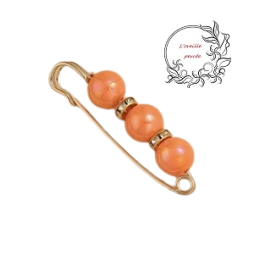 Broche épingle et ses perles rondes oranges à reflet et ses rondelles strass