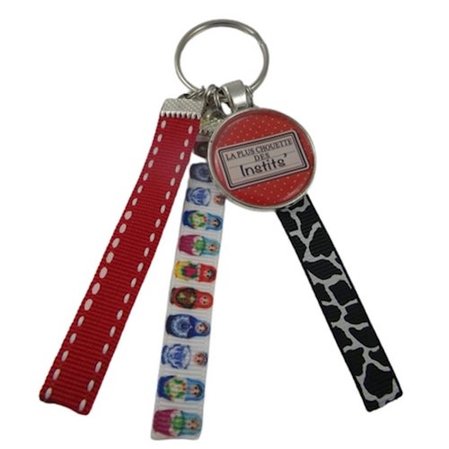 Porte clés rouge et multicolore "la plus chouette des instits"