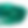 6*5 mm. perles en verre à facettes vert bleuté. fil d'environ 87 perles