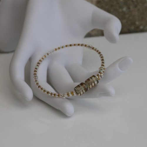 Bracelet s (monté sur fil à mémoire de forme) en perles de verre aux couleurs transparente et dorée modèle "diabolo"