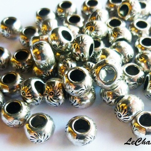 Lot 10 perles en métal argenté soleil maya 7x5mm trou 2.4 mm ronde ovale