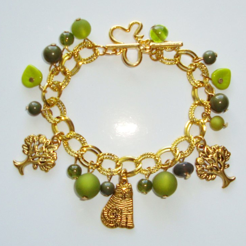 Bracelet breloques chat, arbres et fermoir t en métal doré, perles polaris et en verre pressé vert.
