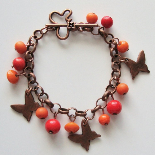 Bracelet breloques en forme de papillon et fermoir t en métal cuivré, perles orange.