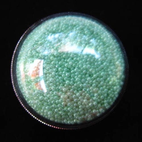 Bague grand dome, microperles vertes claires mobiles, dans une demie-sphère en plexi / diamètre 30mm