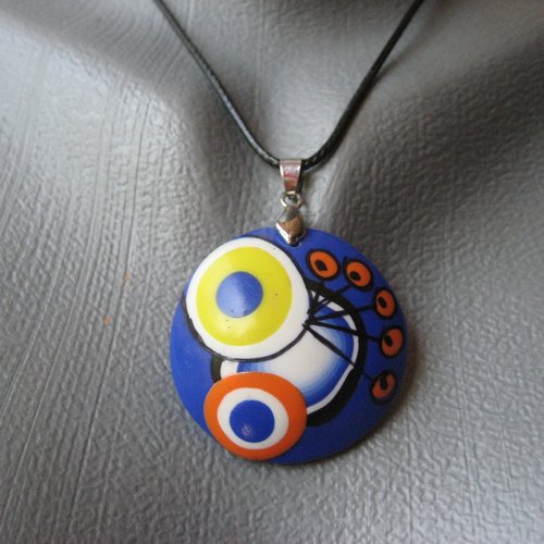 Pendentif unisexe cabochon motifs multicolores sur fond bleu en fimo monté sur un cordon noir diamètre 40mm