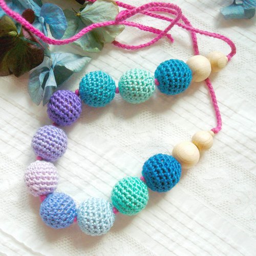 Collier d'aide à l'allaitement dans un camaïeu bleu, violet et vert .