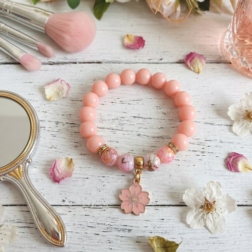 Bracelet fil élastique perles rose orangé et breloque fleur