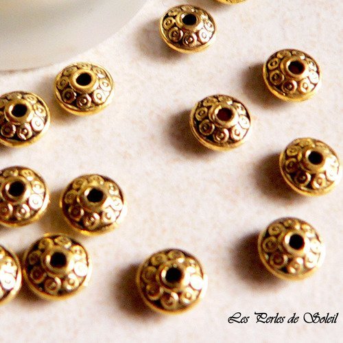 25 perles toupies en metal couleur dorée antique décor fleur 6mm 