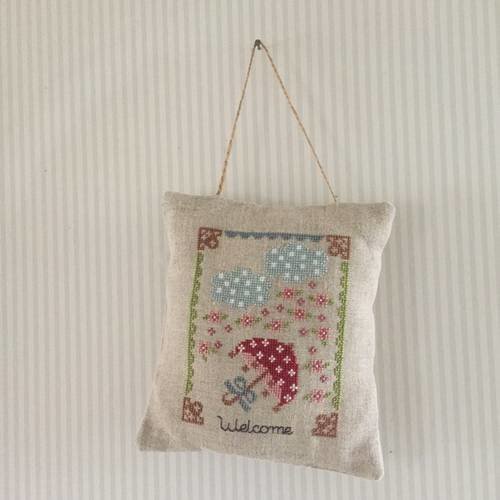 Coussin de porte brodé aux points de croix 