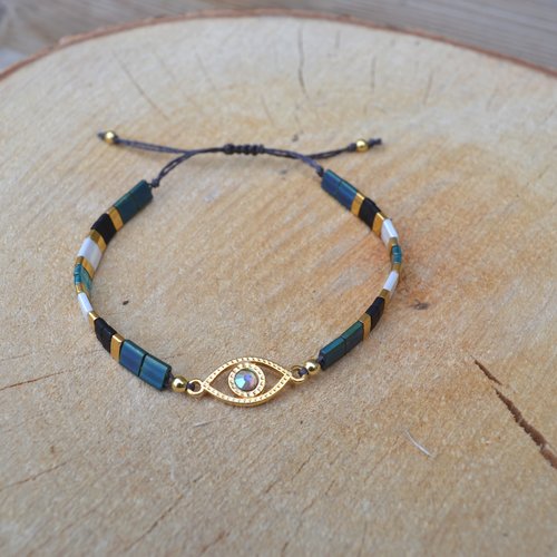 Bracelet miyuki tila & oeil doré à l'or fin agrémenté d'un cabochon swarovski, ton bleu, noir, blanc et plaqué or, finition macramé