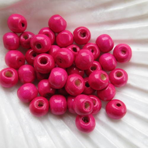 Lot de 50 perles de 8 mm de diamètre en bois peint de couleur: rose tyrien. 