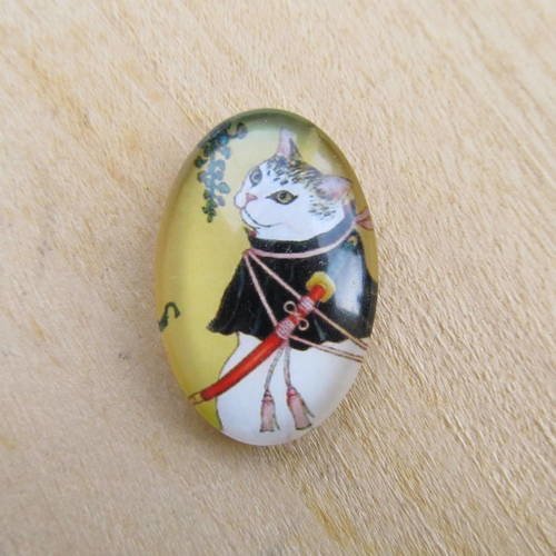 Cabochon en verre de forme ovale de 30 x 20 mm avec image de fond décor: dessin de chat. 