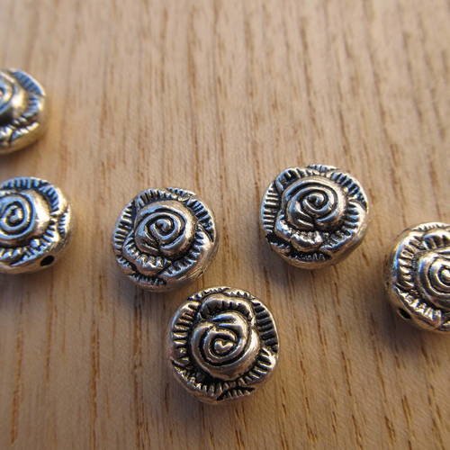 *perle tibétaine en forme de fleur de 10x5mm en métal couleur:  argent vieilli.