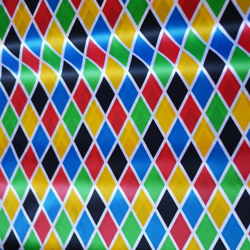 Tissu carnaval arlequin multicolore grand motif 100% polyester, coupe par 50cms