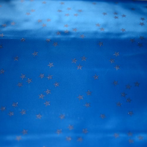 Tissu carnaval merlin bleu etoile argent 100% polyester, coupe par 50cms
