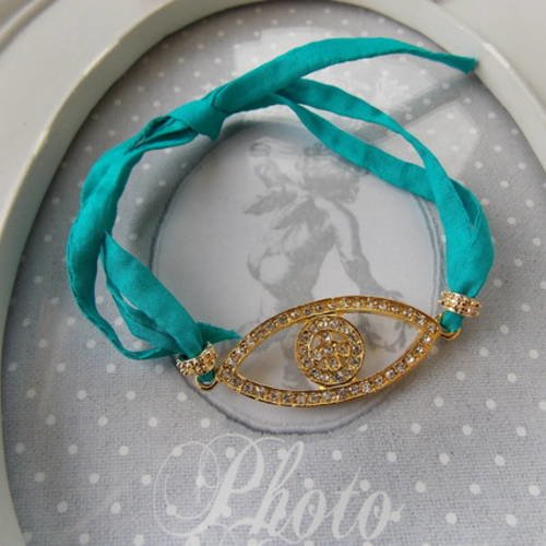 Bracelet oeil protecteur ou "nazar boncuk" doré à strass et ruban de soie turquoise 
