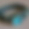 Bracelet mixte cordon en tissu synthétique effet peau de serpent noir et bouton pression en verre oeil de chat bleu