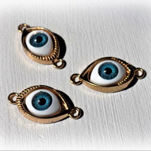 Connecteur œil porte bonheur 30 x 14 mm - pupille bleue monture ton or (à l'unité).