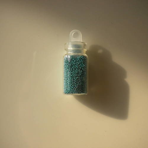 Fiole en verre 25mm avec des microbilles en turquoise 